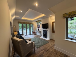 Luxury Suite, Garden View | Desk, laptop workspace, iron/ironing board, free WiFi