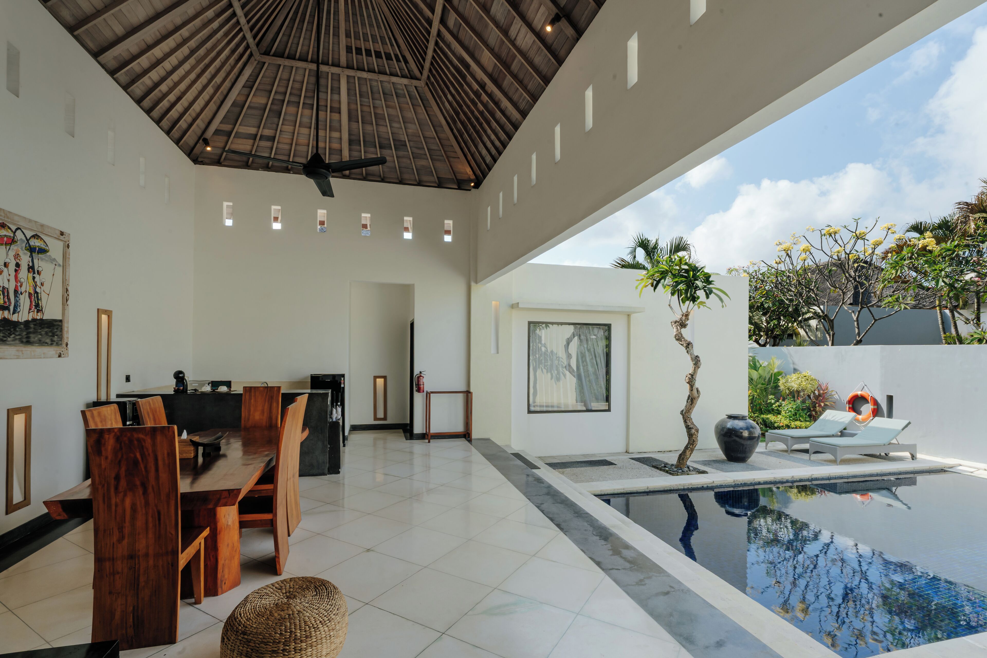 Un interior moderno con comedor, piscina y vistas al exterior.