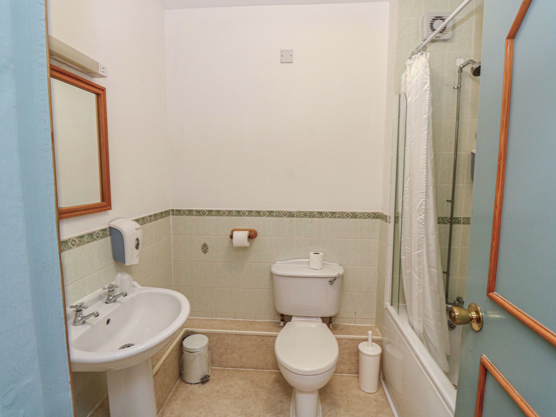 A bathroom with a sink, toilet, and shower.