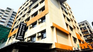 A multi-story hotel with a prominent sign indicating "HOTEL BREEZE BAY". - Hotel Breeze Bay ex (Mumbai)