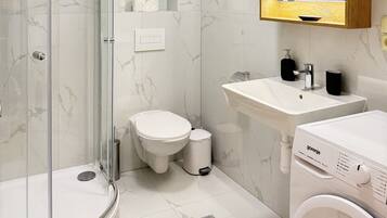 Shower, hair dryer, towels, soap