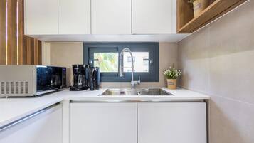 Deluxe Condo | Private kitchen | Full-size fridge, microwave, oven, coffee/tea maker