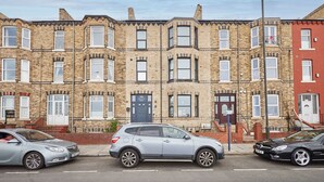A row of terraced houses with a street in front.