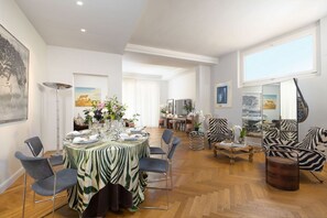 Un comedor con mantel a rayas de cebra, sillas modernas y una mesa de centro de madera.