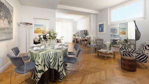 A dining area with a zebra-striped tablecloth, modern chairs, and a wooden coffee table.