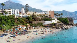 A coastal town with a beach, boats, and buildings. - Villa Las Palomas by At Home Costa del Sol (Torrox)
