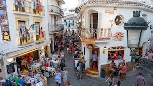 A bustling street scene with outdoor seating at various cafes and restaurants. - Apartamento Sevilla Jimena by At Home Costa del So (Nerja)