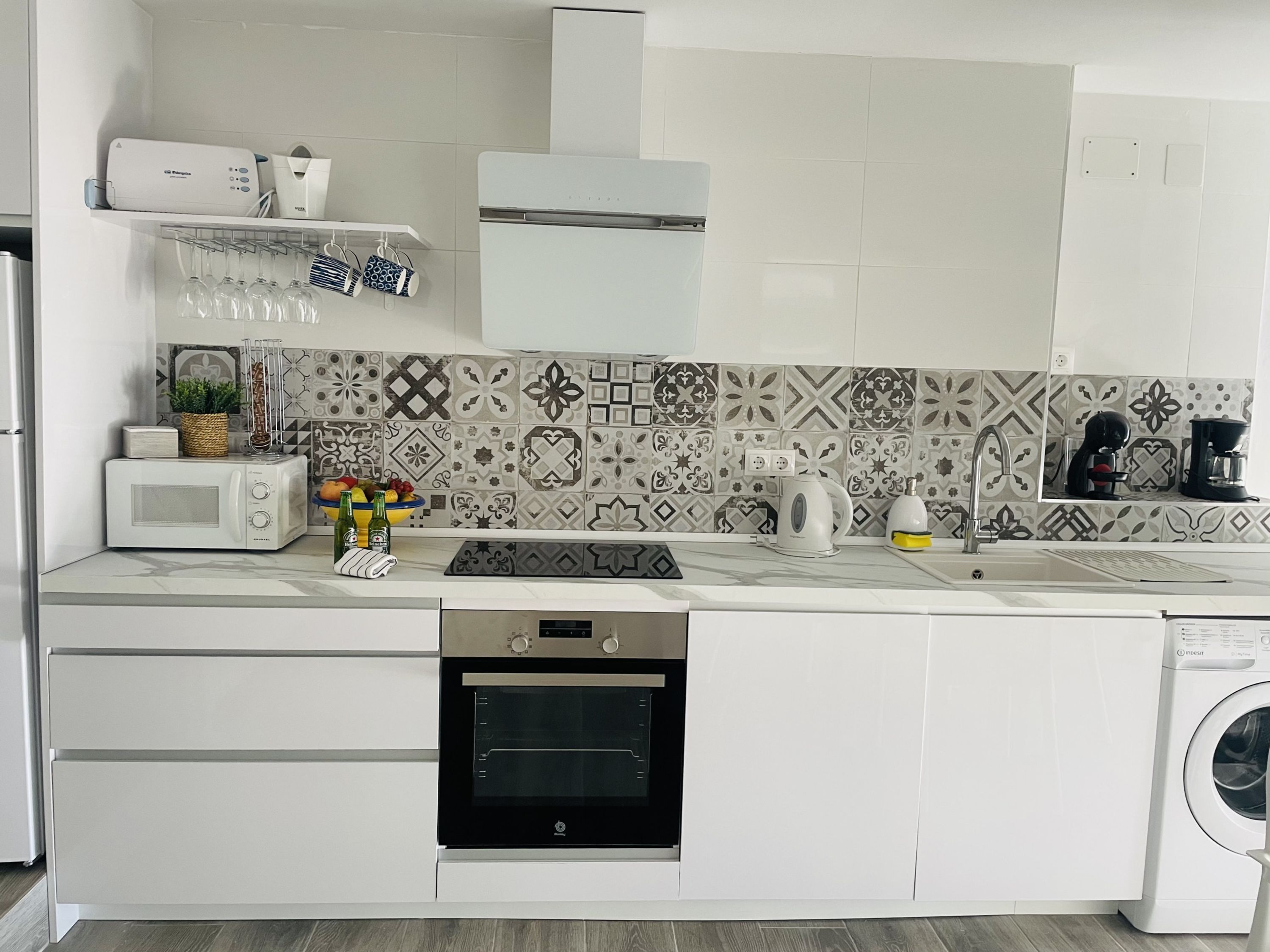 A modern kitchen with a microwave, oven, and dishwasher.