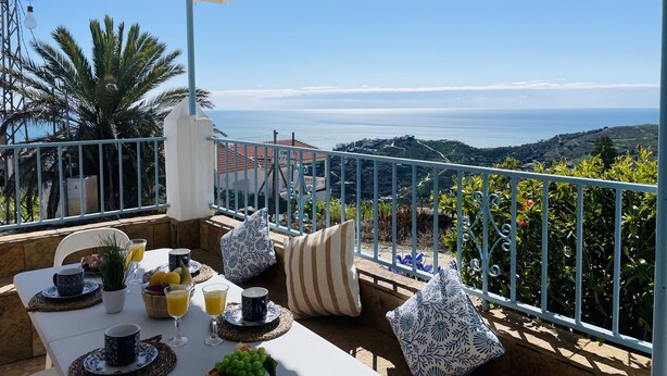 A terrace with a table set for breakfast, overlooking a coastal landscape. - Cortijo Montesue os con Vistas by At Home Costa de (Torrox)