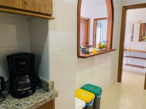 A kitchen with a coffee maker, a fruit bowl, and trash bins. - Casa Blanca con Vistas al mar by At Home Costa del (Torrox)
