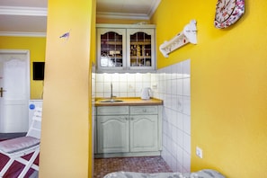 A compact kitchen with a window, a sink, and a small countertop.