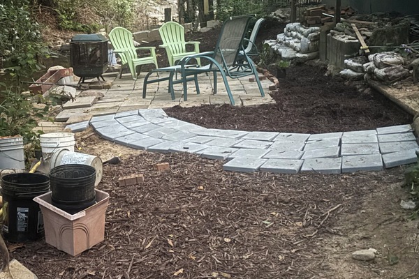 Patio with fire pit by creek