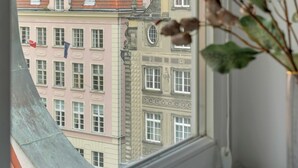 A window view of historic buildings with multiple spires and a clear sky. - Old Town Family Długa Living by Downtown Apartments (Gdańsk)