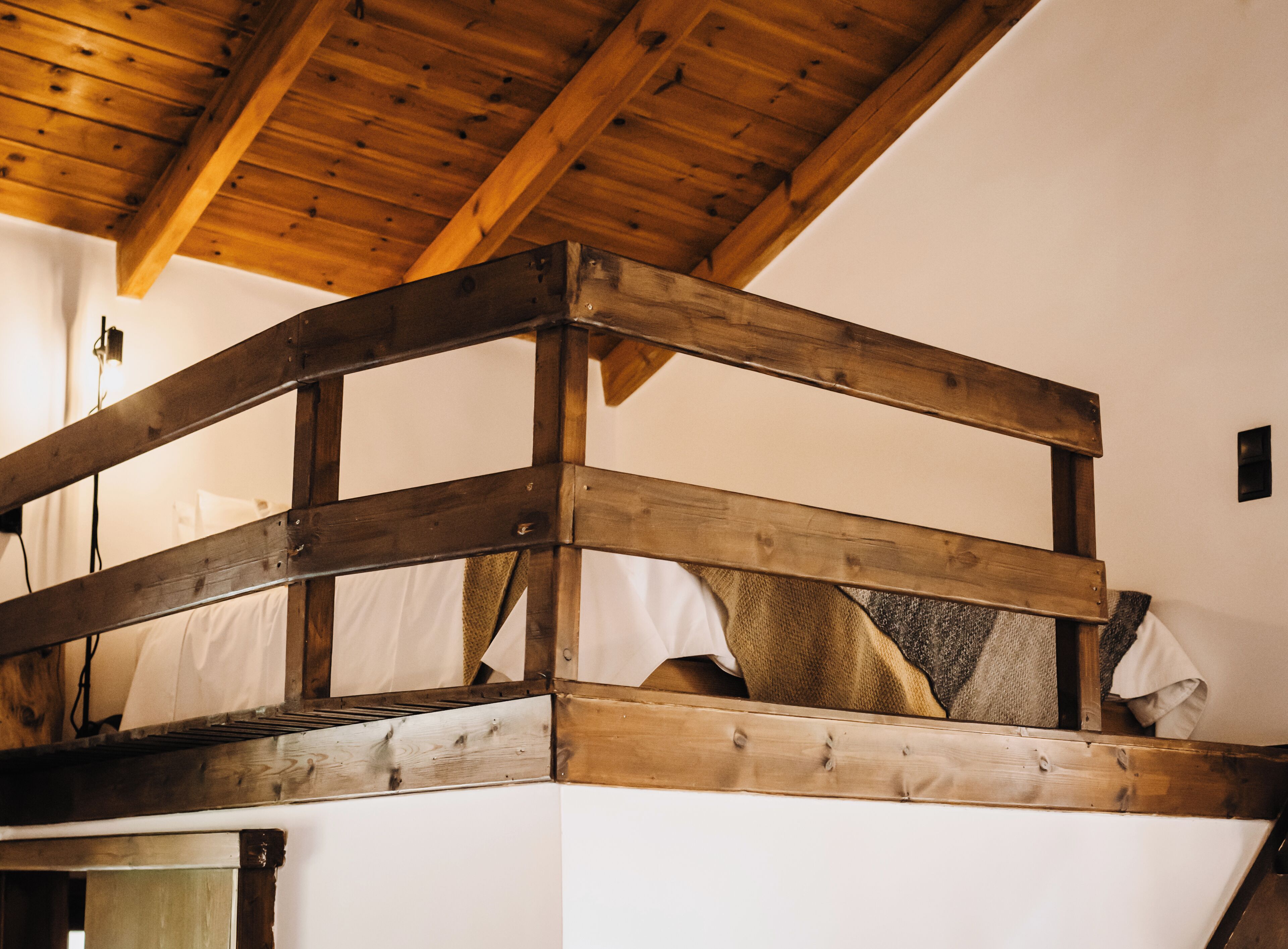 A wooden bunk bed with a simple, rustic design.