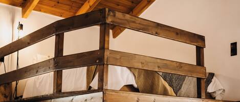 A wooden bunk bed with a simple, rustic design.