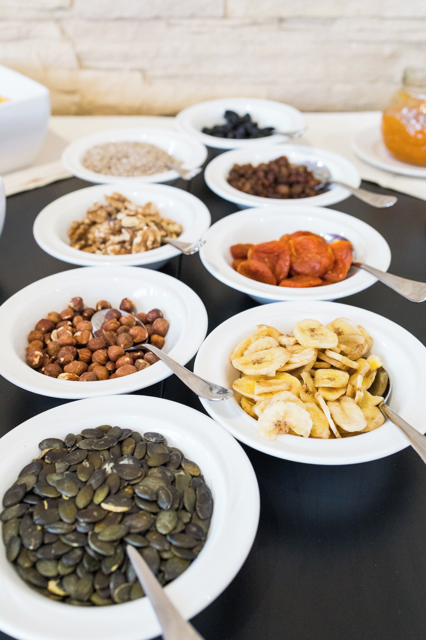 A buffet table with various food items in bowls.