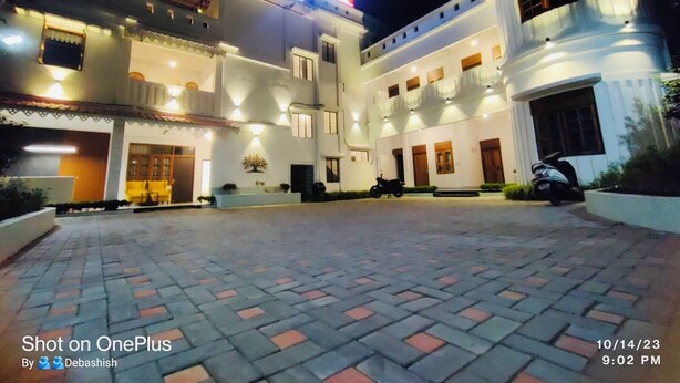 A two-story building with a large entrance and a sign above. - Hotel Insta 18 (Siliguri)