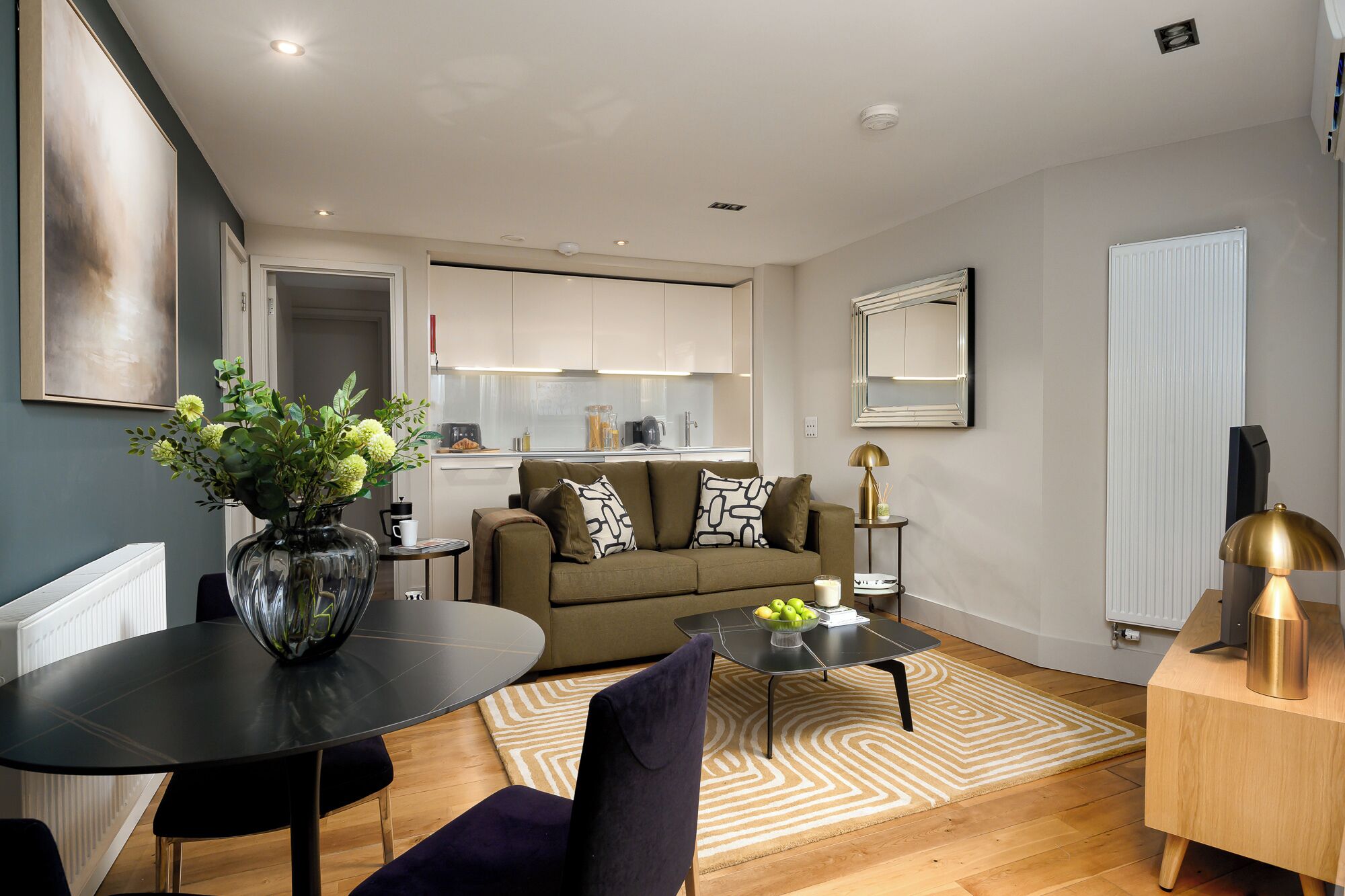 Un salón moderno con sofá, mesa de centro y zona de comedor.