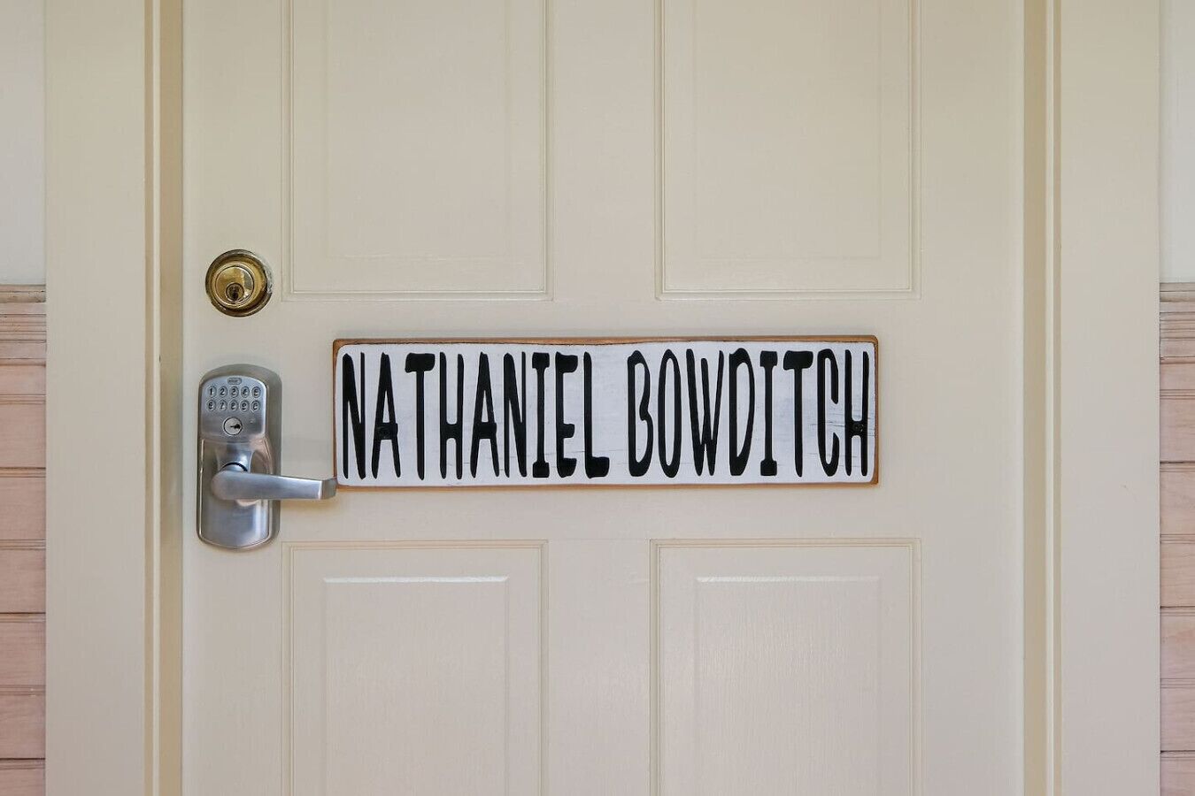 A door with a nameplate reading "NATHANIEL BOWDITCH" and a modern electronic lock.