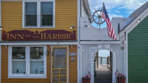A building with a sign reading "Inn on the Harbor" and an American flag. - Inn on the Harbor (Stonington)
