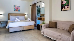 A bedroom with a bed, a sofa, and a small table with a plant. - Ionian Serenity House (Zakynthos)