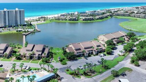 A resort with a central lake, beachfront, and multiple buildings. - Boardwalk Villas 298 - Community Pool, Lake Front, Great Amenities + Dining! (Miramar Beach)