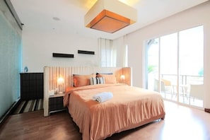A modern hotel room with a large bed, a ceiling light fixture, and a view of the outdoors. - Chic 4BR Oasis With Gazebo, Your Dream Getaway (Cheras)