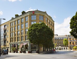 A multi-story building with a prominent 'Z' sign, large windows, and a tree in front. - The Zetter (London)