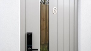 A door with a numeric keypad lock and a small window.