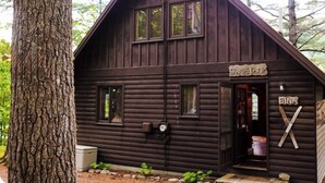 A rustic cabin with a sign reading "GRAYS CAMP" and a nameplate "EINA". - Gramps Camp • Moose Pond (Bridgton)