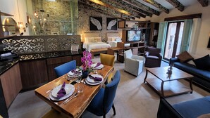 A modern interior with a dining area, a living room, and a kitchen.