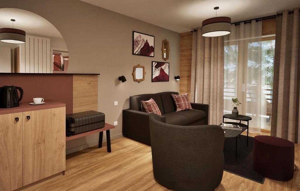 A modern living room with a sofa, a coffee table, and a small side table. There is a wooden cabinet and a bench.