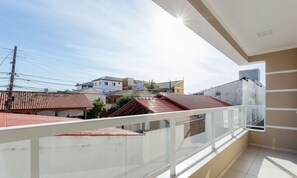 A balcony with a view of neighboring buildings and a clear sky. - Apt 500m From Ingleses Beach, Floripa Rid3106 (Florianópolis)