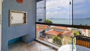 A balcony with a view of the sea and buildings. - Charming Apt With Balcony and Sea View Edj0410 (Florianópolis)