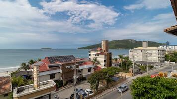 A coastal town with buildings, a beach, and a view of the sea.