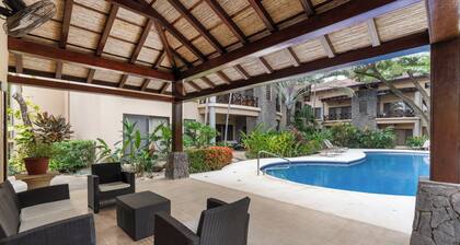 Modern Island-Themed Condo with Floor-to-Ceiling Windows & Garden and Pool Views Within Walking Distance of the Beach