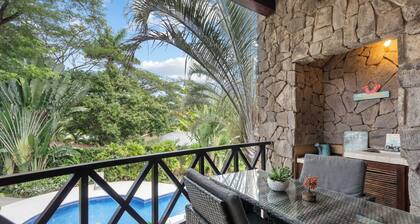 Modern Island-Themed Condo with Floor-to-Ceiling Windows & Garden and Pool Views Within Walking Distance of the Beach