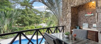 Modern Island-Themed Condo with Floor-to-Ceiling Windows & Garden and Pool Views Within Walking Distance of the Beach