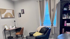 A modern living room with a leather sofa, a small desk, and a bookshelf. - Terry Townhouse Two (Cave City)
