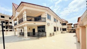 A multi-story building with a central courtyard, balconies, and a flat roof. - Classic 2-Bedroom house in East Legon

Share

Save (Accra)