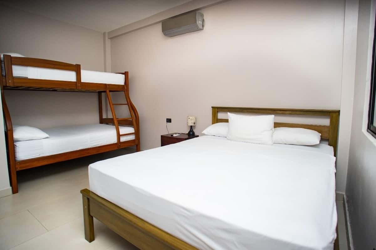 Ein Zimmer mit zwei Etagenbetten und einem Einzelbett.