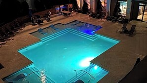 A rooftop pool area with lounge chairs and a clear blue pool. -  Feel at home in our 2 Bed 2 Bathroom, pool view, game room,  palace in Atlanta. (Atlanta)