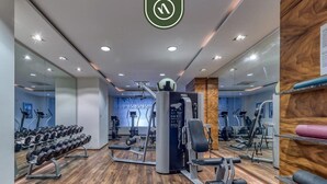 A gym with various exercise equipment, including dumbbells, a bench press, and cardio machines. - The Park 506 | 2BR/2BA | Puerto Vallarta | Pool, Gym (Puerto Vallarta)