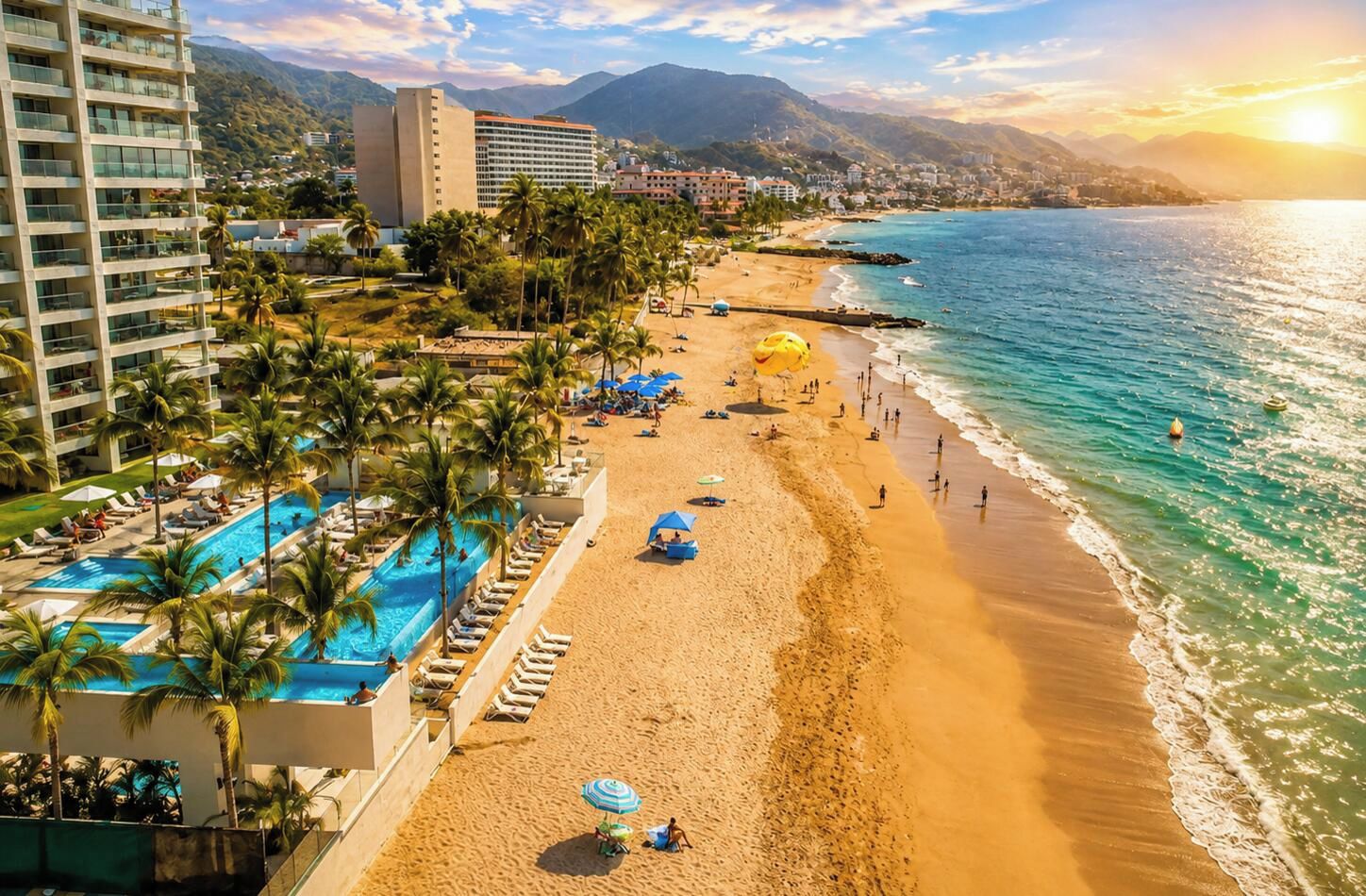 A beach resort with a swimming pool, beach umbrellas, and a view of the ocean.