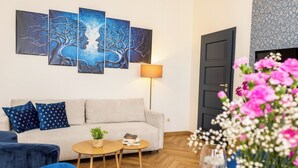 Una sala de estar con un sofá, una mesa de centro, una lámpara y una puerta.