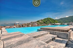 A rooftop pool with a view of a cityscape and a hill. - Fall Promo 1 BR Condo with Terrace - Rooftop Pool (Puerto Vallarta)