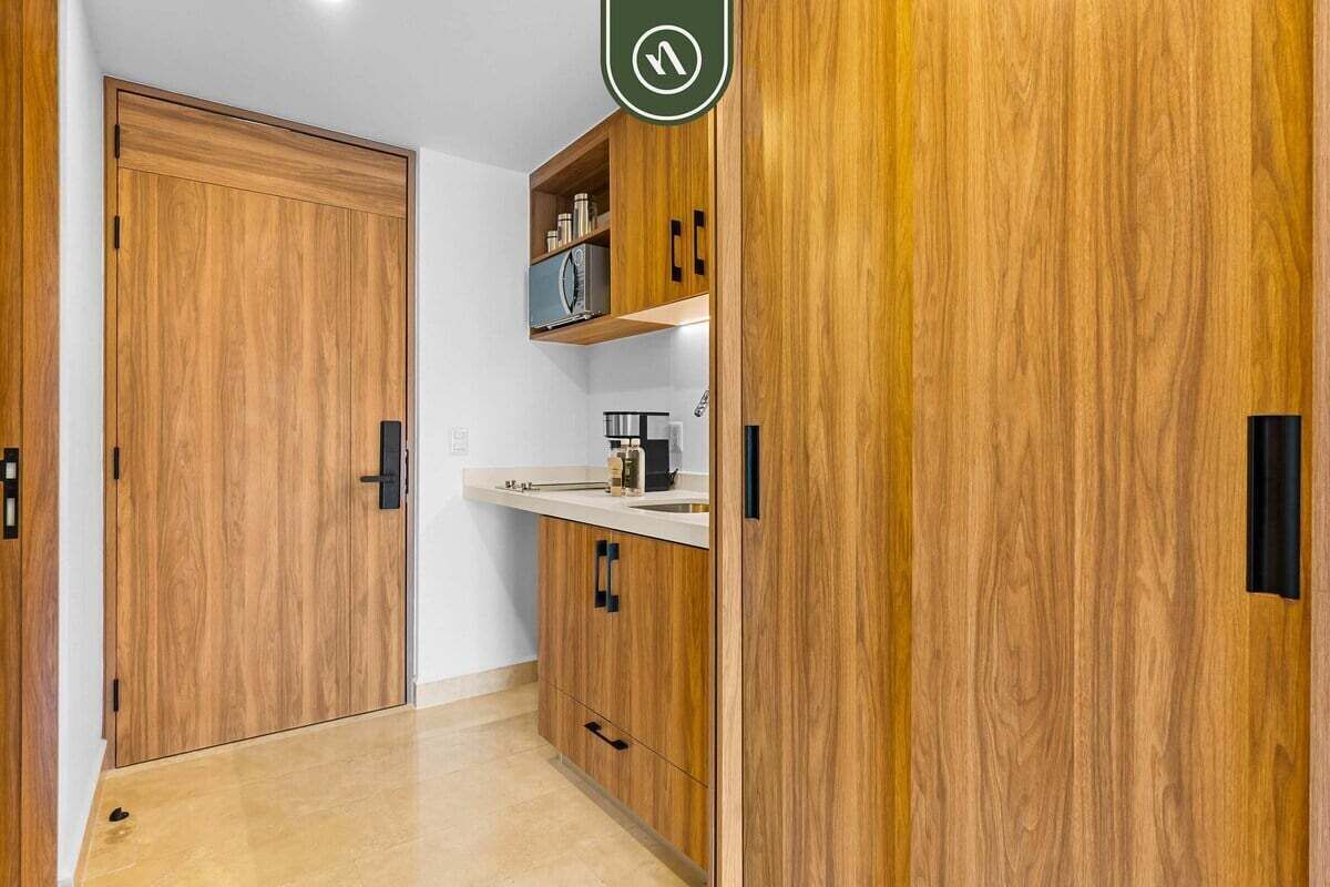 A kitchen with wooden cabinets, a countertop, and a sink.