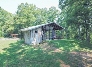 A rustic cabin with a wooden exterior, a porch, and a small deck. - High Point Hide-A-Way w/ Internet and a Hot Tub! (Chattanooga Valley)