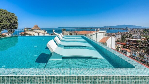 A rooftop infinity pool with a clear view of the city and ocean. - Sea View Residences 302 | 2BR/2BA PV | Pool & Beach (Puerto Vallarta)