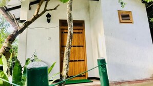 A white building with a wooden door and a small window. - Ella Ostella (Ella)
